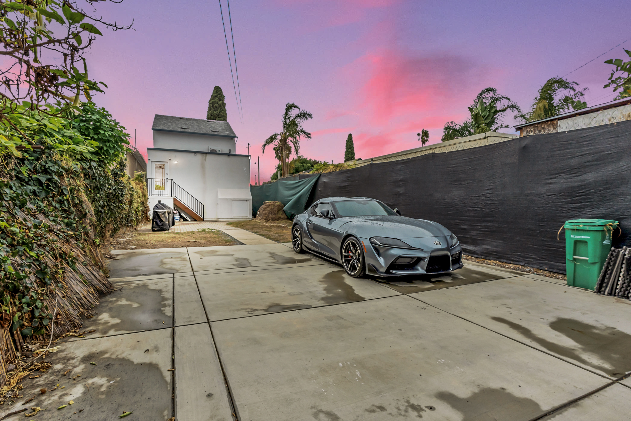 Driveway and rear yard at 2146 Franklin Avenue in Logan Heights showing gated parking and build-ready site for detached ADU duplex. Listed by Portia Green, REALTOR® at Compass in San Diego.